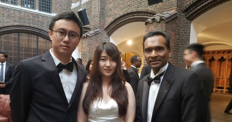 Dr. Jie Luo with his wife, Hui Li,  and Dr. Arul Chinnaiyan. They are celebrating Chinnaiyan's Sjoberg Award.